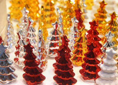Bunch of shiny decorative Christmas trees figurinesの写真素材