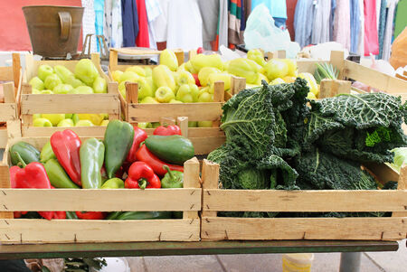 Wooden crates full with fresh vegetables sold on green marketの写真素材