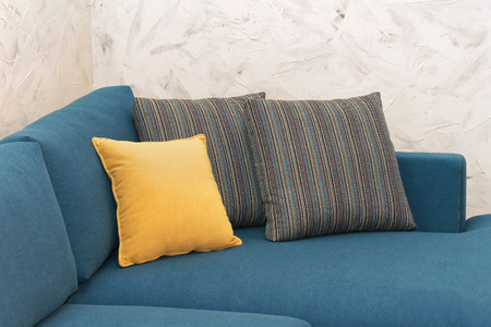 Decorative pillows on corner of modern sofa