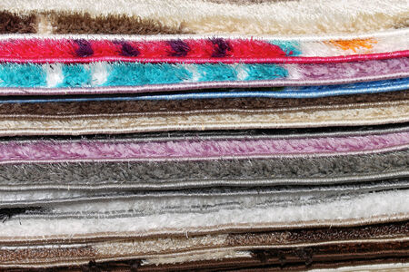 Big stack of fluffy materials usually used as decorative rugs in interior floorsの写真素材