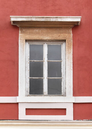 Aged closed window on old building facadeの写真素材
