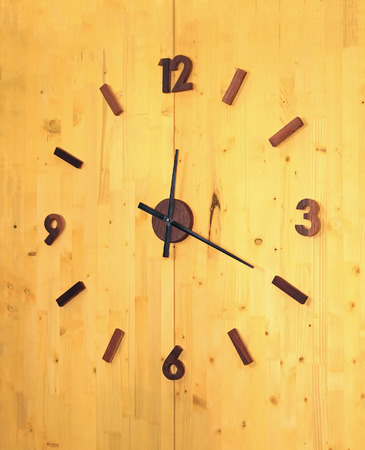 Retro wall clock on wooden backgroundの写真素材