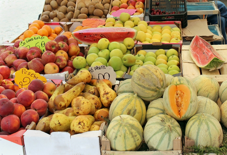 Fresh fruits piles sold on market stallの写真素材