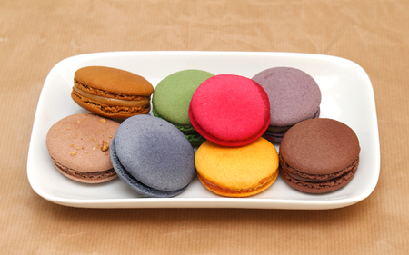 Sweet colorful macaroons pile on ceramic plateの写真素材