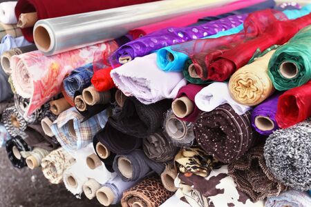 Big pile of modern pattern fabric rollsの写真素材