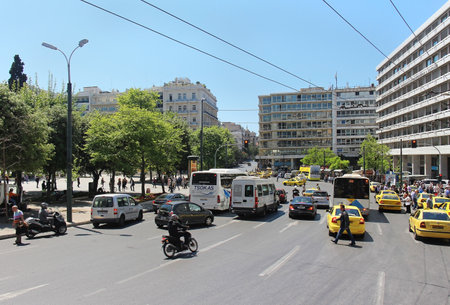 ATHENS, GREECE - May 04; Busy street traffic on Syntagma square in Athens, Greece - May 04, 2015; Traffic rush with many yellow cabs and other cars and public transport vehicles making driving difficult and slow.のeditorial素材