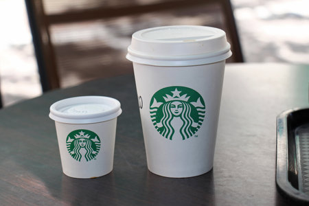 ATHENS, GREECE - MAY 04, 2015: Takeaway hot coffee paper cups at Starbucks store in Athens. Starbucks is an American global coffee company and coffeehouse chain.のeditorial素材