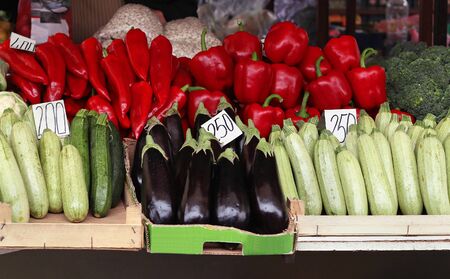 Vegetables piles inside crates on market stallの写真素材