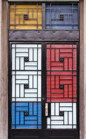 Closed metal door with decorative colorful panelsの写真素材