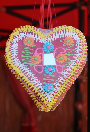 Gingerbread heart decoration sold on carnival fairの写真素材