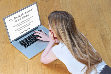 Young girl looking at her laptop upset because of first world problem - loss of internet connection