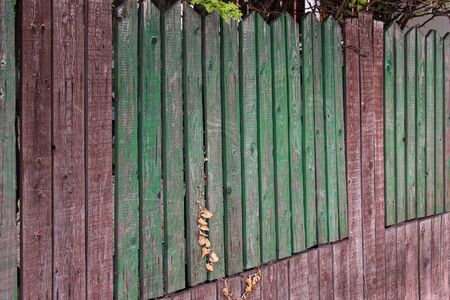 Old rural wooden fence with cracked parts