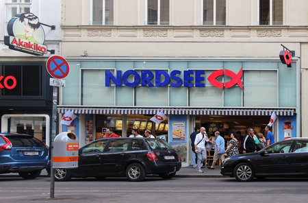 VIENNA, AUSTRIA - JULY 10, 2015; Nordsee is famous German fast-food restaurant chain specialising in seafood in Vienna, Austria - July 10, 2015: Tourists walking in front of Nordsee fast-food restaurant in the Vienna city centreのeditorial素材