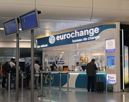 ATHENS, GREECE - May 05: Tax refund and currency exchange counter at Athens International Airport Eleftherios Venizelos with people waiting in line in Athens, Greece - May 05, 2015; People waiting in line at the airport to submit papers for tax refund of のeditorial素材