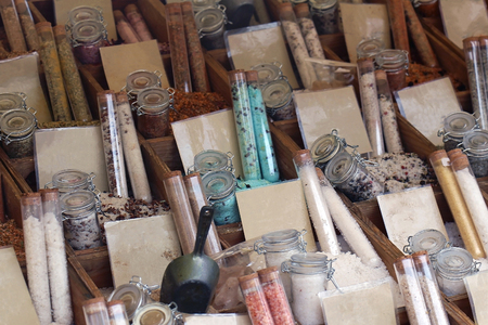 Market stall detail with spices in tubes and jarsの写真素材