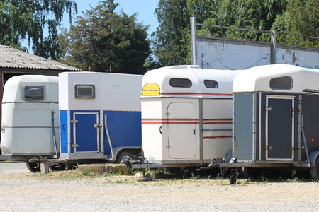 Trailers for horse transportation parked near racetrackの写真素材