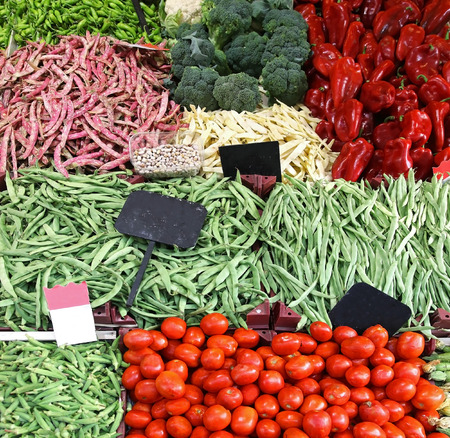 Fresh organic vegetables in piles on market stallの写真素材