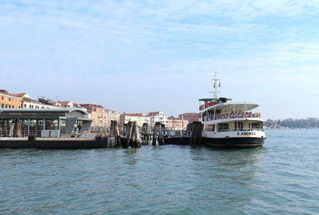 VENICE, ITALY - JANUARY 09; One of public boat transport Vaporetto stops with people waiting to board in Venice, Italy - January 09, 2017: Vaporetto is water bus network with 19 scheduled lines that serve locals and tourists within Venice.のeditorial素材