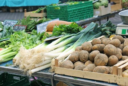 Potato and green vegetables on market stallの写真素材