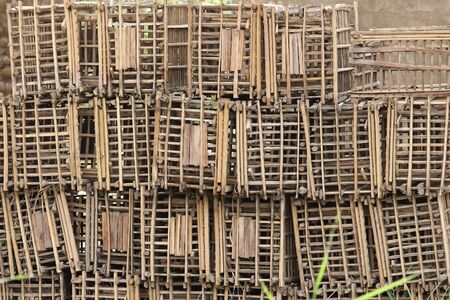Bunch of old damaged wooden crates stacked outsideの写真素材