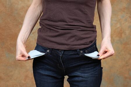 Woman in blue jeans showing empty pocketsの写真素材