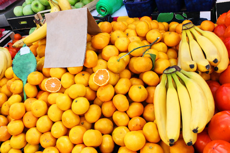 Organic citrus fruits pile on market stallの写真素材