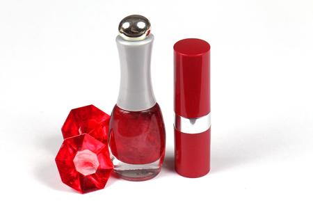Ruby red lipstick and nail polish on white backgroundの写真素材