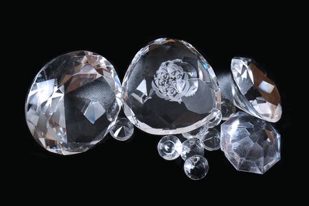 Pile of clear sparkling gem stones on black backgroundの写真素材