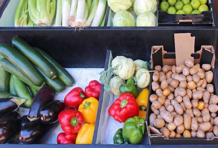 Organic fresh vegetables piles on market stallの写真素材