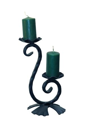 Vintage iron candlestick with green candles isolated with clipping pathの写真素材