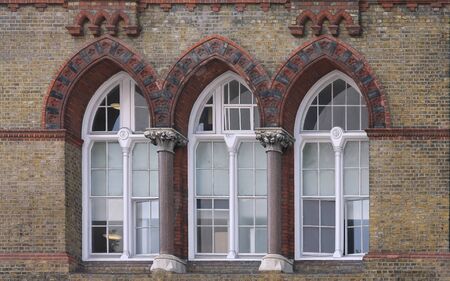Antique closed windows on old building facadeの写真素材