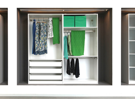 Open wardrobe full of female green clothesの写真素材