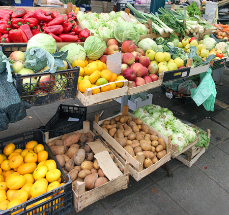 Large market stall with piles of fruits and vegetablesの写真素材