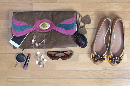 Female fashion accessories on wooden floor ready for next dayの写真素材