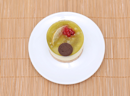 Tasty lime cheesecake dessert on white ceramic plateの写真素材