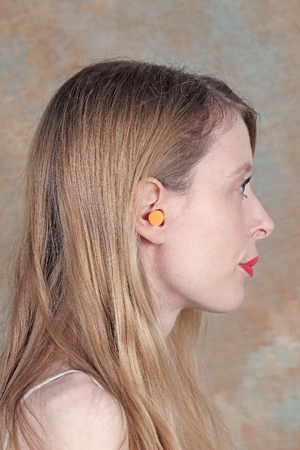 Woman wearing ear plug as noise cancellationの写真素材