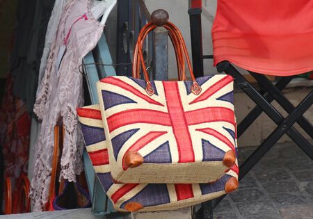 Union Jack flag on handbag and summer dress on outside marketの写真素材