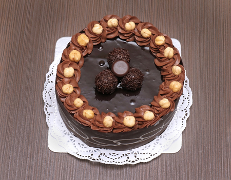 Tasty chocolate cake with hazelnuts on white plateの写真素材