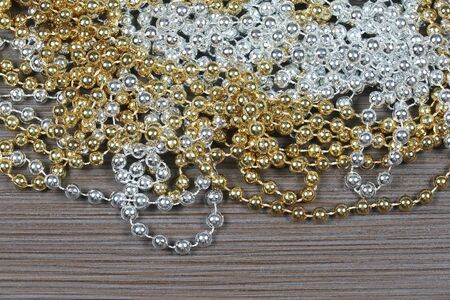 Pile of shiny gold and silver pearl necklacesの写真素材