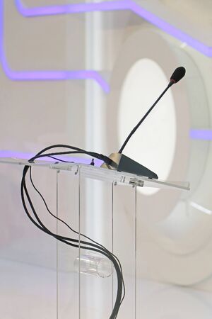 Modern conference podium with microphone on glass standの写真素材