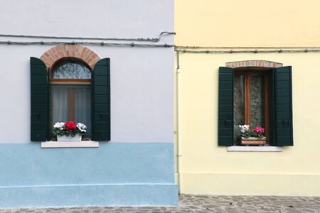 Open retro windows on colorful facades housesの写真素材