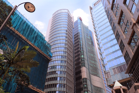 Tall skyscraper buildings with glass facades in Kowloon part of Hong Kongの写真素材
