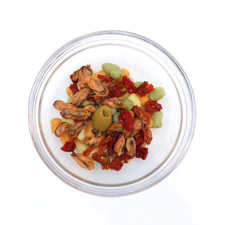 Gnocchi with clams and tomato in glass bowl on white backgroundの写真素材