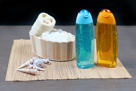 Shower gel in sparkling containers with bath spongeの写真素材