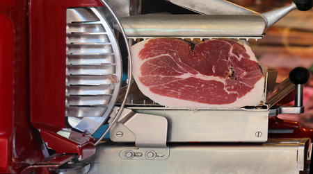 Italian prosciutto inside slicer machine sold on marketの写真素材