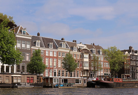 Traditional Dutch architecture houses on coast of Amstel river in Amsterdamの写真素材