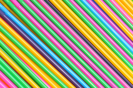 Colorful plastic drinking straws in diagonal pattern backgroundの写真素材