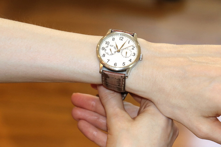 Elegant retro female wrist watch woman holding with her handの写真素材