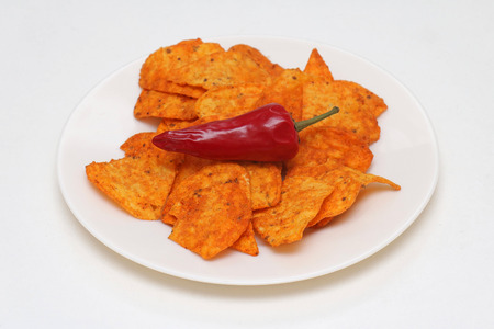 Red hot potato chips with spicy pepper on top of pileの写真素材
