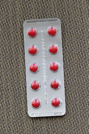 Red pills in silver blister as prescription drug bought in pharmacyの写真素材